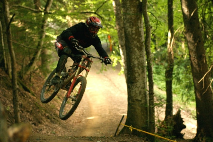 Downhill biker on the road in the forest with optical MTB googles from SK-X